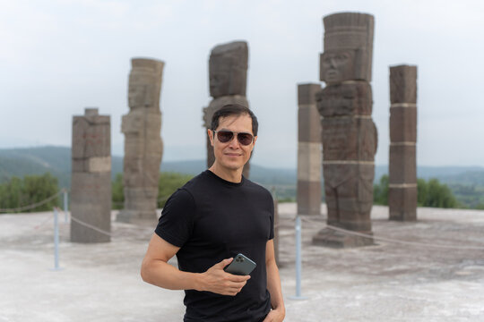Portrait of Smiling Male Tourist Holding Smartphone at Tula Archaeological Site Mexico