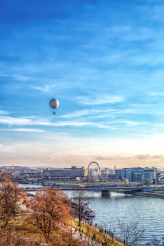 Krakow town over Vistula river with flying hot air balloon and Ferris wheel in Poland