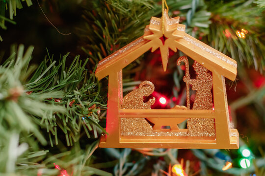 Nativity ornament on a Christmas tree, background