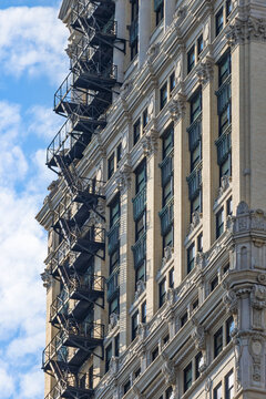 Building facade with fire escape on sunny day