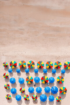 Aerial top view of colorful beach umbrellas on the sand, Recife, Pernambuco, Brazil