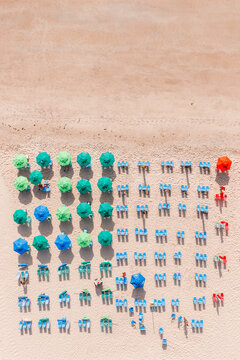 Aerial top view of beach umbrellas and chairs in a row, Recife, Pernambuco, Brazil