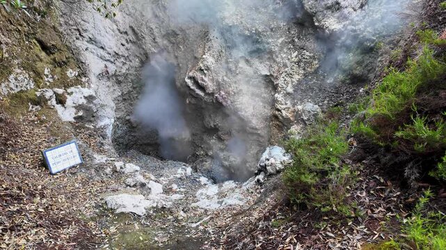 Footage of an active geothermal fumarole releasing dense steam from volcanic ground in Furnas on Sao Miguel Island Azores Portugal showcasing the region's powerful geothermal activity