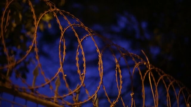 Static footage of a wire fence, showcasing metal textures, structural details, and an outdoor environment in a simple yet visually compelling composition.