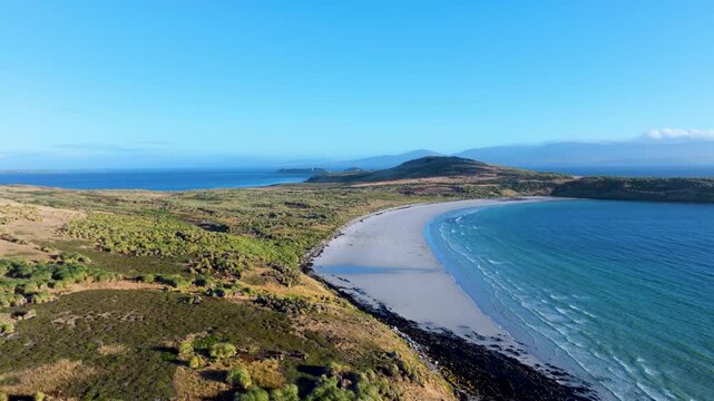Aerial drone footage of the curving coastline, open bay and rolling landscape of Carcass Island in the Falkland Islands,  remote nature theme.