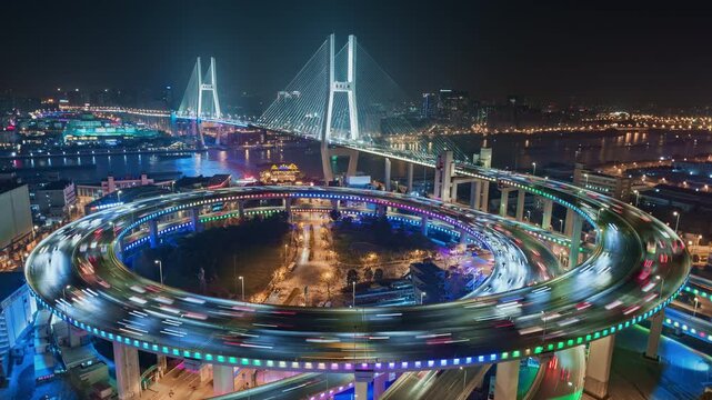  Cityscape zoom out time lapse of Nanpu bridge illuminated at night with neon lights, with evening time rush hour commuters 