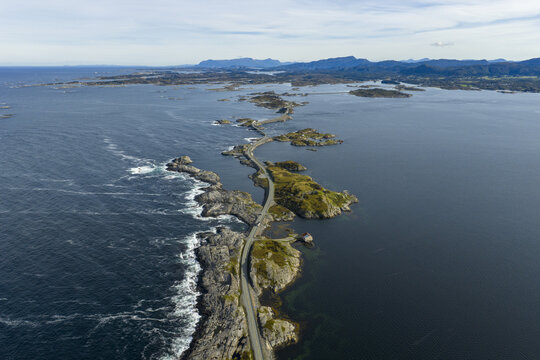 Aerial view of The Atlantic Road winding across small islands and bridges surrounded by the Norwegian Sea in Averoy, More og Romsdal, Norway.