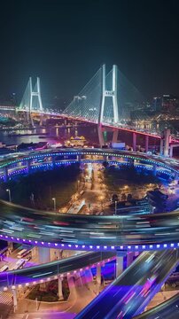  Vertical time lapse of Nanpu bridge illuminated at night with neon lights, with evening time rush hour commuters 
