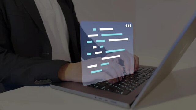 Developer using laptop computer to write application code.
