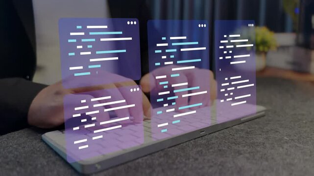Developer using laptop computer to write application code.