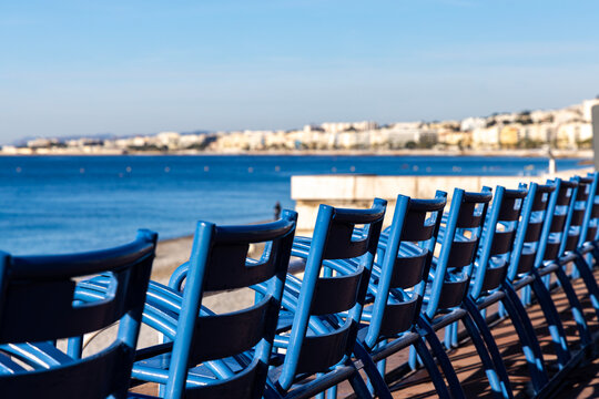 Blue chairs on the Promenade des Anglais in Nice, France.