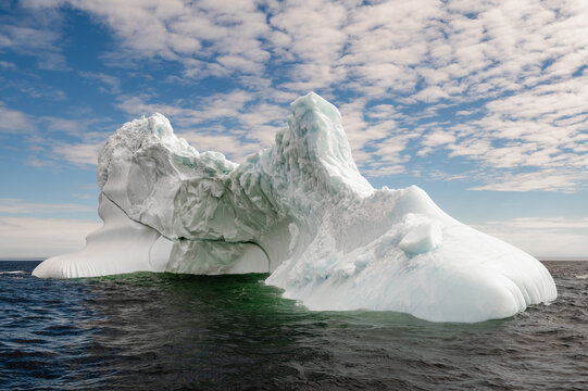 Majestic iceberg floating on the cold ocean water on summer day