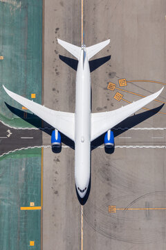 Large passenger jet on the airport tarmac from above