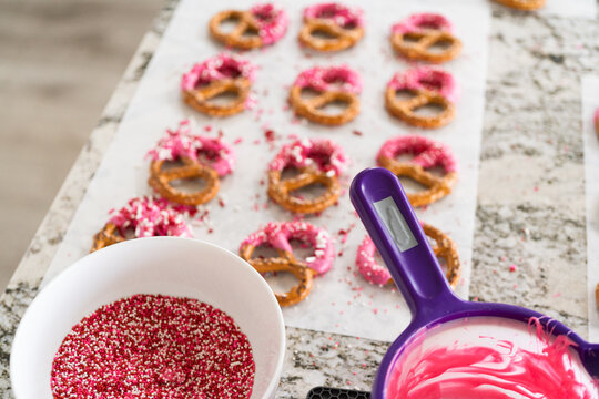 Homemade Gourmet: Delightful Pretzels Adorned with Pink Chocolate and Sprinkles