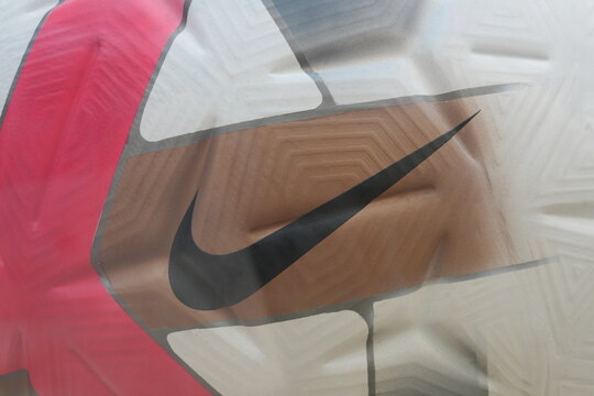 A close-up shot shows a Nike logo on a soccer ball surface.