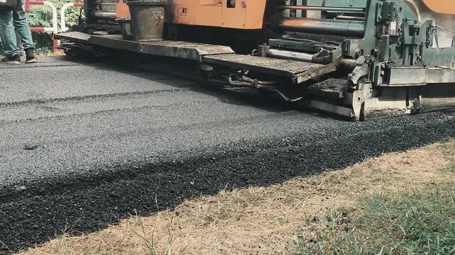 The asphalt paver is laying asphalt, Chiangmai Thailand.