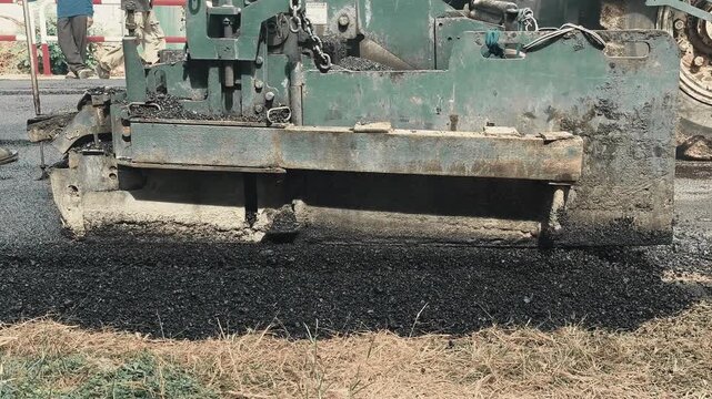 The asphalt paver is laying asphalt, Chiangmai Thailand.