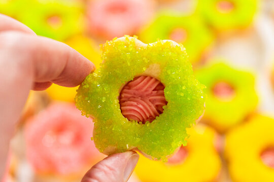 Hand Holding Green Flower Cookie Sandwich