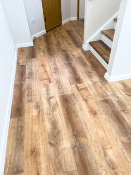 Wooden Floor and White Baseboard in Bright Interior