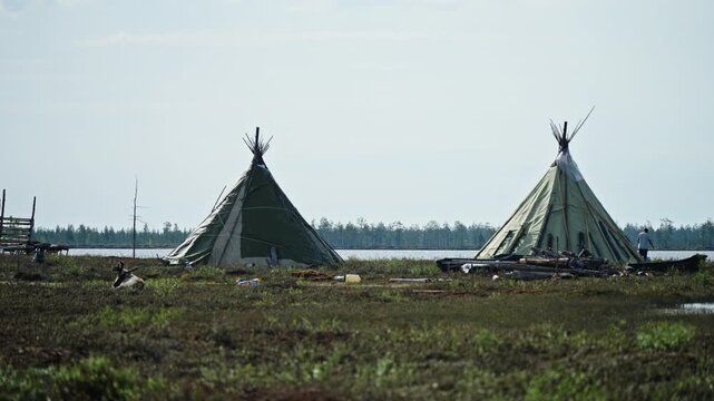 Nomadic Conical Tents on Tundra Lakeshore in Remote Northern Wilderness