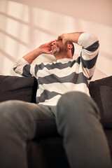 Fototapeta premium Man with painful headache and toothache at home.