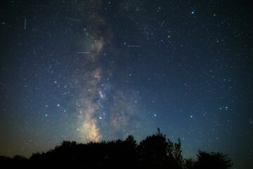 Fototapeta premium Summer Milky Way stars and landscape scenery silhouettes.