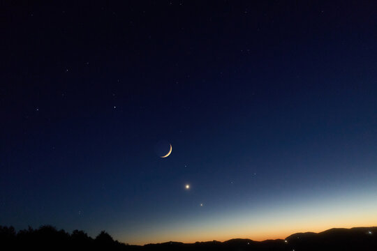 Crescent Moon, planet conjunction and landscape scenery silhouettes.