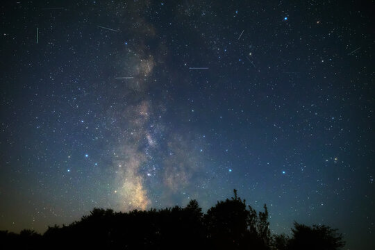 Summer Milky Way stars and landscape scenery silhouettes.