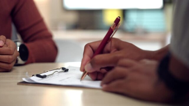 Close-up of a woman signing a contract document at an office desk. Suitable for concepts of agreement, legal paperwork, business approval, official documentation, and professional decision-making.