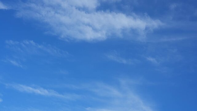 A blue sky timelapse video featuring soft cirrus and thin cirrostratus clouds flowing like airy brushstrokes, suggesting sky therapy, clean atmosphere, mindful breathing, and peaceful natural motion.
