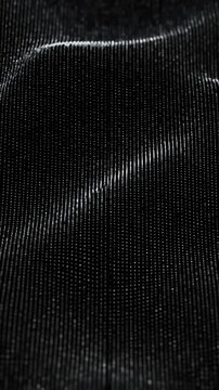 Shimmering black fabric texture with silver dots and ripples
