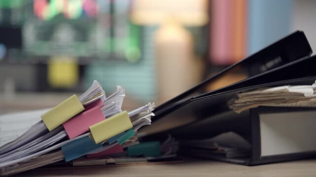 Organized Office Documents with Color Tabs on Desk