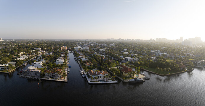 Aerial view of the Tarpon River winding through residential neighborhoods with luxury waterfront homes, private docks, and lush tropical vegetation in Fort Lauderdale, Florida, United States.