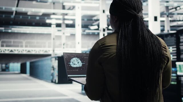 IT professional runs equipment checkups in a data center, supporting equipment checkups, infrastructure maintenance, network monitoring and reliable server infrastructure management.