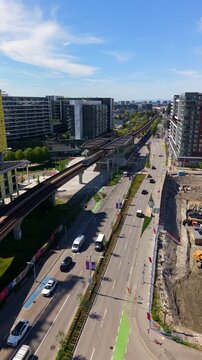 Vertical View Of TransLink's Canada Line SkyTrain Station Through The City Near YVR&ndash;Airport In Richmond, British Columbia, Canada. Aerial Drone Shot