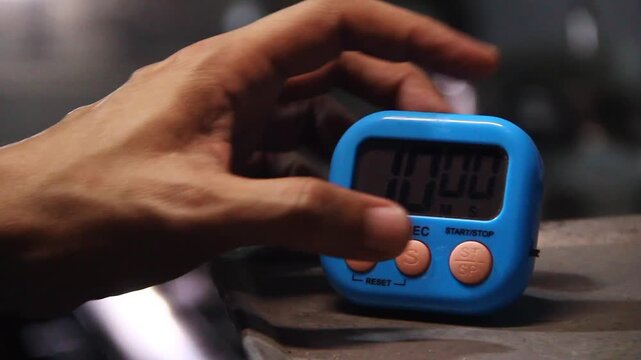 Hand setting time on a kitchen timer