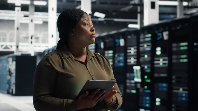 Worker works inside a data center to support system stability, equipment checkups, software updates and organized technical operations within a practical data center workflow.