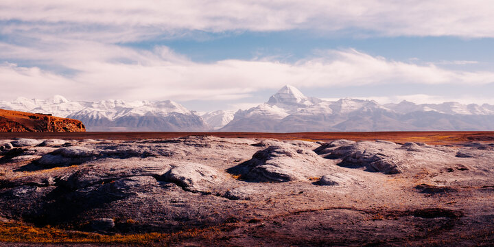 The sacred Mount Kailash rises above the intricate patterns of the nearby alkali flats. 