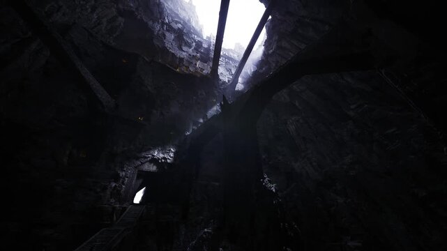 light piercing collapsed roof through beams broken supports and scattered rubble, rusted metal frame, hazard textures and tilted angles, cinematic grit