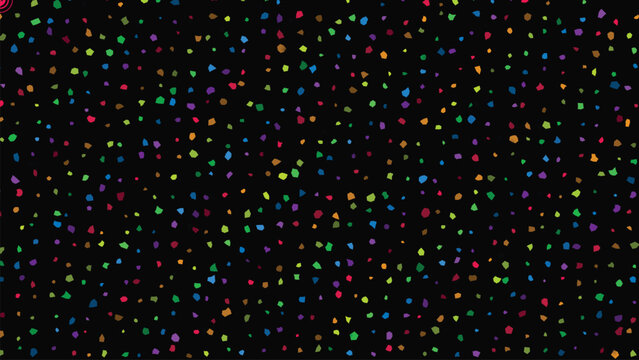 Abstract background featuring small colorful confetti pieces scattered over dark black surface.