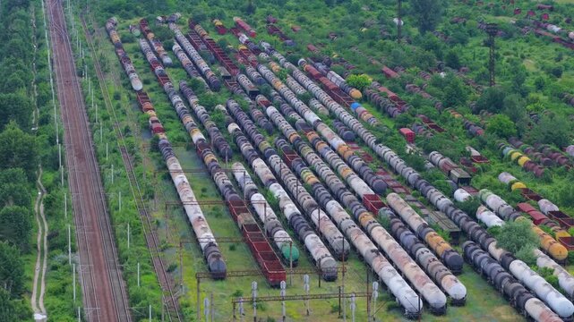 Aerial view flying over railway marshalling yard with cargo trains