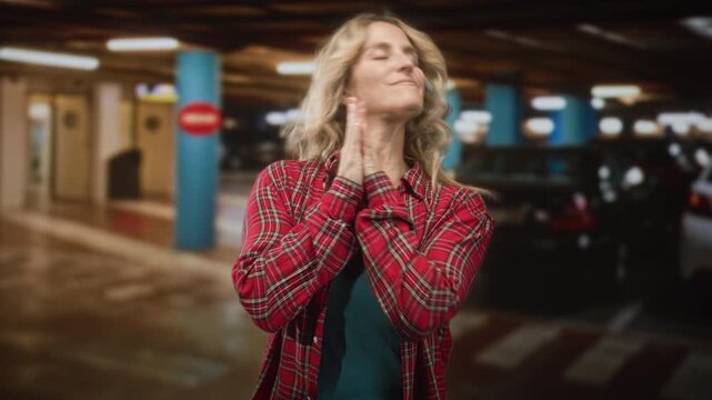 Woman with hands clasped to cheek in sleeping gesture inside building near parked cars; serenity rest.