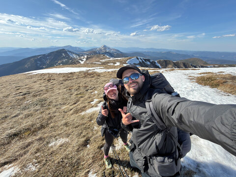 Smiling hikers couple taking selfie on mountain summit Carpathian mountains Ukraine