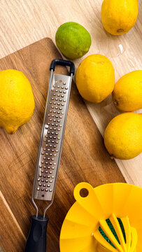 Fresh lemons with zester and juicer on wooden countertop in bright light, ideal for food blogs recipes lifestyle and social media, 5 May 2026 Subitica, Serbia