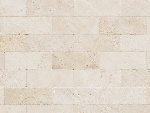 Beige stacked limestone brick wall texture background
