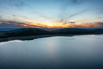 Fototapeta premium Southern Urals in spring: Irendyk ridge and Talkas Lake at sunset.