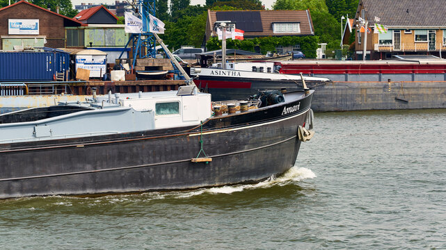 Inland shipping and cargo transport, barge "Amanti" navigating the Oude Maas river in Dordrecht, Netherlands