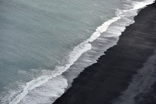 Aerial view of waves crashing on Reynisfjara black sand beach Iceland