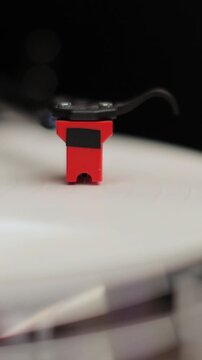 Vertical video Close-up of a vinyl record and a turntable needle. Vintage vinyl record player.