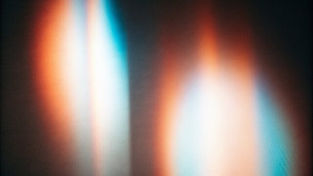 Holographic rainbow light leak overlay featuring iridescent prism reflections, glowing spectral streaks, cinematic film grain and dreamy optical flare, abstract futuristic background